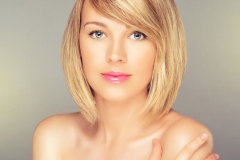 Beautiful Blonde Woman with Blonde Bob Hairstyle and side swept bangs.